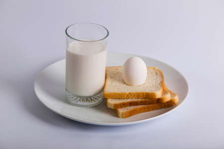 closeup bread slice top egg milk glassの写真素材