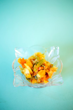 Fried vegetables in plastic bag on turquoise background, selective focusの写真素材