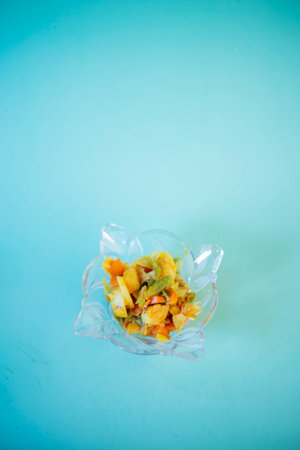 Frozen vegetables in plastic bag on blue background. Vegetarian food.の写真素材