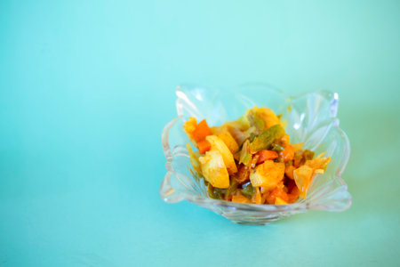Fried vegetables in glass bowl on blue background. Selective focus.の写真素材
