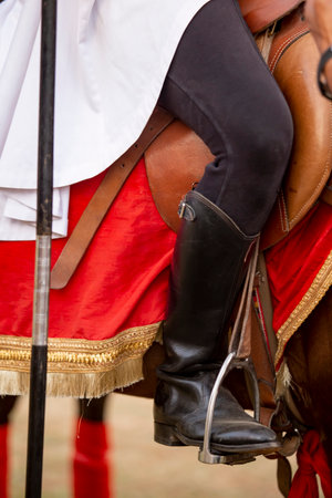 Close-up of the legs of a medieval knight on horsebackの写真素材