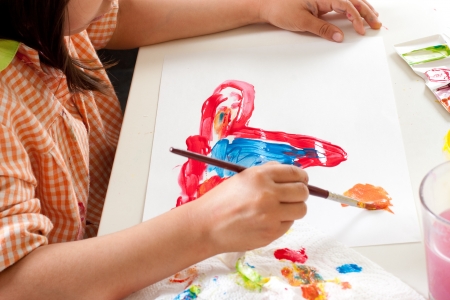 Hands of child painting with paintbrushの写真素材