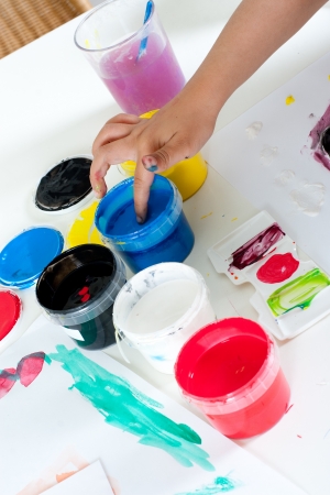 Hand of child painting with fingers の写真素材
