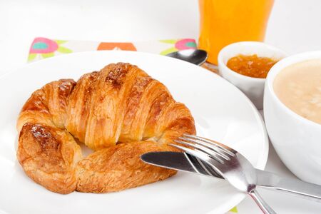 Breakfast with croissant, coffee with milk, apricot jam and orange juice   Copy space の写真素材