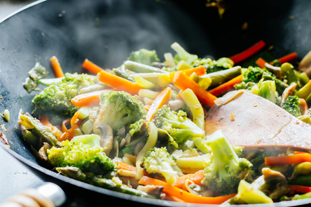 Wok stir fry with vegetables steamingの写真素材
