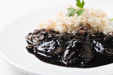 Squid in its own ink with brown rice. Traditional Spanish recipeの写真素材