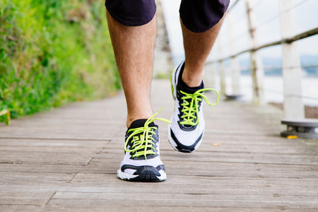 Legs and shoes of a running man