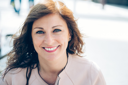 Portrait of a beautiful, happy and smart business woman taking a break outdoorsの写真素材