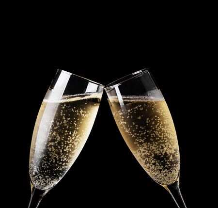 Two glasses of champagne toasting isolated on blackの写真素材