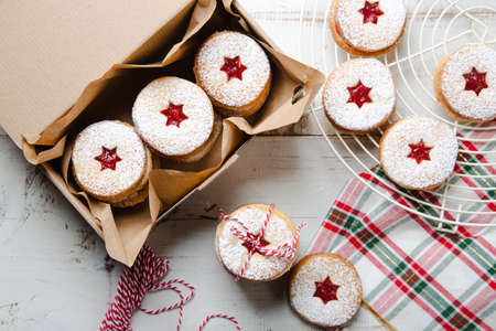 Traditional Linzer Christmas cookies made of almond and butter filled with raspberry jam to make a...