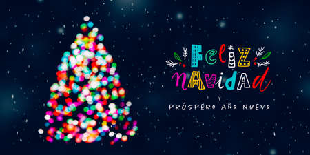 Feliz Navidad greeting with Christmas tree made of colorful defocused Christmas lights at snowing night and funny letteringの写真素材