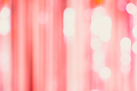 Abstract background with stripes and lights bookeh in pink and red colors made of a glitter curtainの写真素材