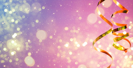 Celebration party background with a golden streamer, glitter, sparks and lights bokehの写真素材