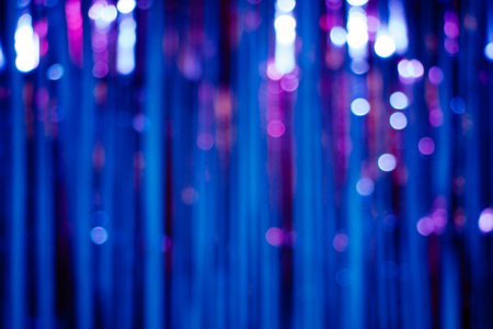 Abstract background with stripes and lights bookeh in blue and purple colors made of a glitter curtainの写真素材