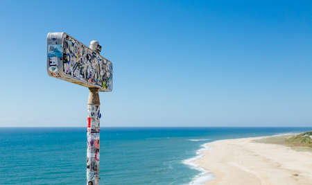 NazarÃ©, Portugal - June 29, 2021: Landmark signal fully covered with several brands and logos stickers in Praia do Norte famous for its surfing conditionsのeditorial素材