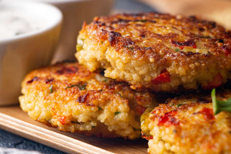 Gluten free vegetarian millet and vegetable burgers served with yogurt sauceの写真素材