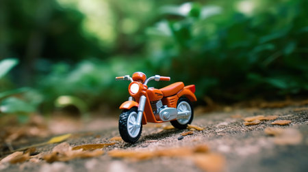 Toy motorcycle on the ground in the forest. Selective focus.の素材