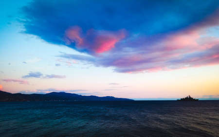 Bright colors in the sky, with the sea getting dark.の写真素材