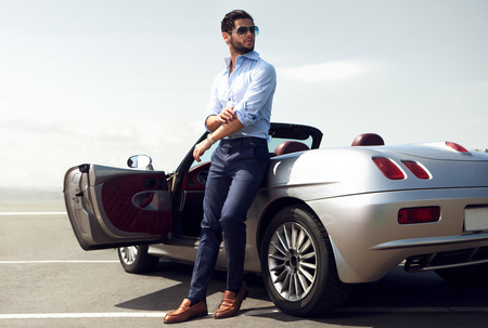 Handsome man near the car. Luxury life.