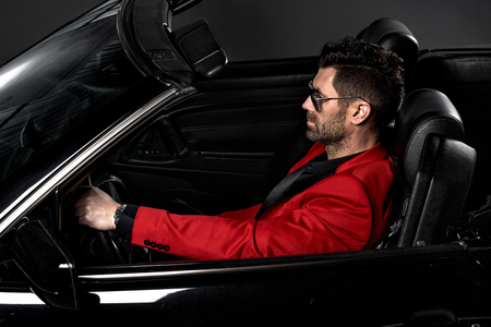 Handsome brutal man in the carの写真素材