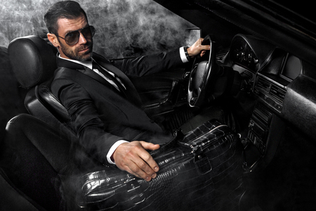 Handsome brutal man in the car. Luxury. Night life.の写真素材
