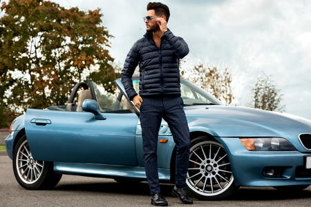 Successful, handsome man near the car.の写真素材