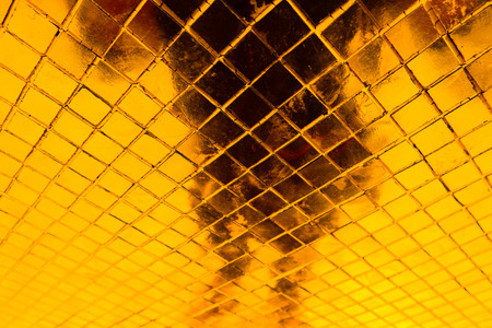 Beautiful closeup textures abstract tiles and black gold and yellow color glass pattern wall background and art wallpapersの写真素材
