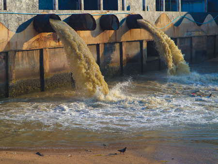 Industrial and factory waste water discharge pipe into the canal and seaの写真素材