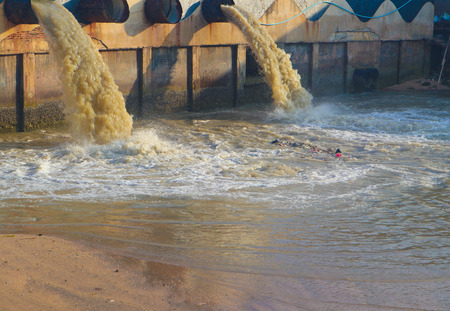 Industrial and factory waste water discharge pipe into the canal and seaの写真素材