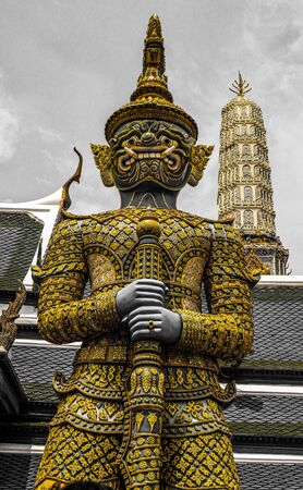 Beautiful close up color black white and gold Wat Phra Kaew or Temple of Emerald Buddha, Guardian statues pagoda and Grand palace located within the grounds of the Grand Palace in Bangkokの写真素材