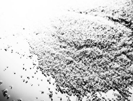 Beautiful white glitter texture on the black background and light glitter sparkle confetti gray grainy abstract texture on a black background and wallpaperの写真素材