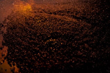 Beautiful gold glitter texture on the black background and golden glitter sparkle confetti gold...
