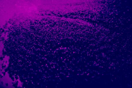 Beautiful pink and purple glitter texture on the black background and light glitter sparkle confetti...