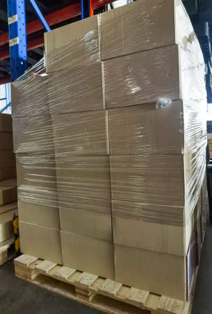 Shipment cartons box on pallets and wooden case on hand lift in interior warehouse cargo for export...