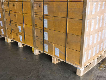 Shipment cartons box on pallets and wooden case on hand lift in interior warehouse cargo for export...