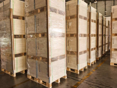 Shipment cartons box on pallets and wooden case on forklift in interior warehouse cargo for export...