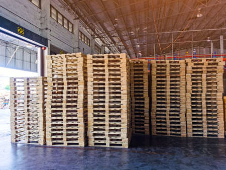 Wooden pallets stack in warehouse cargo storage, shipment in logistics and transportation industrial, wood pallets heap, delivery serviceの写真素材