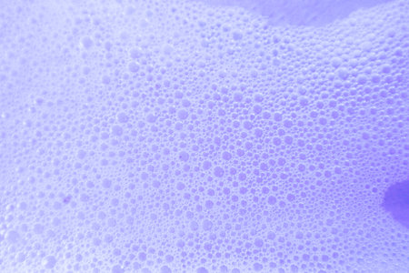 Beautiful abstract purple soap bubbles on white background, white and blue foam bubble textureの写真素材