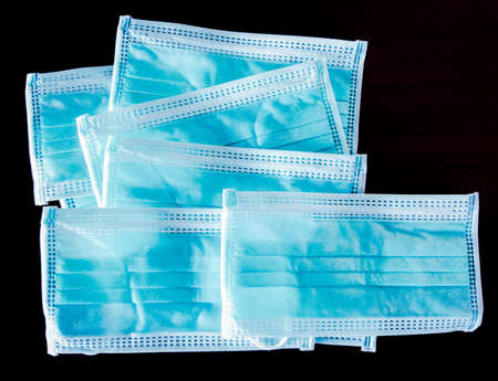Blue surgical face mask on black background,  Health care concept and can protect virus covid-19の写真素材