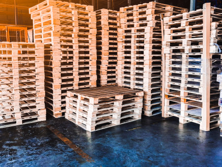 Worker driving forklift loading shipment carton boxes goods on wooden pallet at loading dock from container truck to warehouse cargo storage in freight logistics, transportation industrial, deliveryの素材 [FY310160618535]