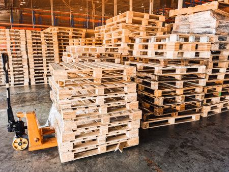 Worker driving forklift loading shipment carton boxes goods on wooden pallet at loading dock from...