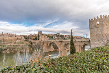 View of Toledo walls, Monastery of San Juan de los Reyes and Puente de San Martin Bridge over the (Tajo) Tagus Riverのeditorial素材
