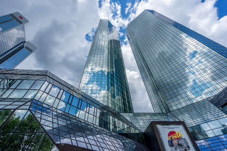 Frankfurt, July 26, 2016. Skyscraper buildings scenery. Deutsche Bank Filiale building complex from Taunusanlage street ground level with cristal cloud reflections .のeditorial素材