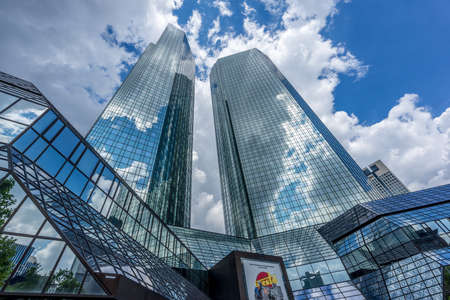 Frankfurt, July 26, 2016. Skyscraper buildings scenery. Deutsche Bank Filiale building complex from Taunusanlage street ground level with cristal cloud reflections .のeditorial素材