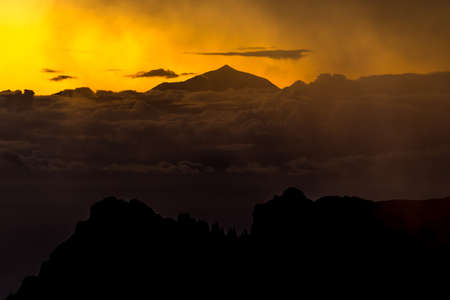 Sunset and mountain misty landscape view of El teide from La Ventana del nublo. One of the higest places in Gran Canaria Island.の写真素材