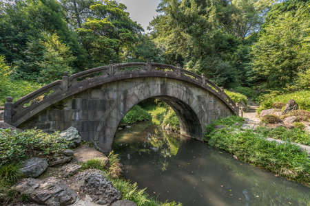 Engetsu-kyo stone bridge at Koishikawa Korakuen Garden. The origin of the Name Engetsukyo which literally means "Full Moon" is because the reflections of the arch on the water form a full moon. Located in Bunkyo Ward, Tokyo, Japanの写真素材