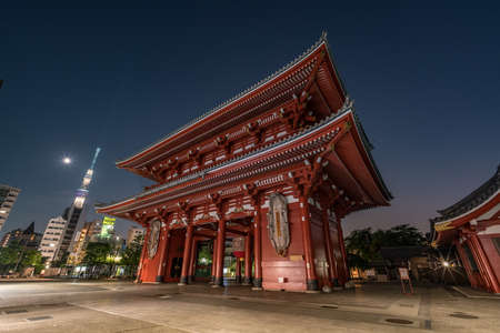 Hozomon gate at Senso-ji Temple in Asakusa . Late Night Cityscape. Shining moon, mars  and Tokyo SkyTree in the background. Tokyo, Japan