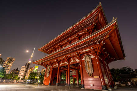 Taito Ward, Tokyo - August 2, 2018 : Hozomon gate at Senso-ji Temple in Asakusa. Late Night Cityscape. Shining moon, mars  and Tokyo SkyTree in the background