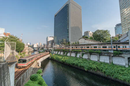 Local trains crossing Ochanomizu station and Kanda River from Hijiri-bashi Bridge. Border of Bunkyo and Chiyoda Wards downtown Tokyo, Japanのeditorial素材