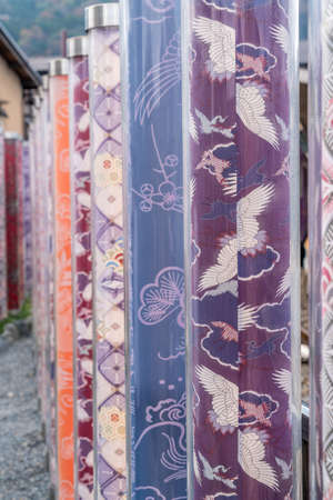 Arashiyama, Kyoto, Japan - November 9, 2017 : Kimono Forest at Randen Arashiyama Station, colorful cylinder-shaped pillars with kimono patterns of dyed fabric in Kyo-Yuzen style of dyeing and printingのeditorial素材
